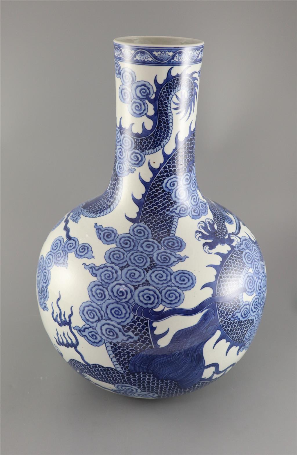 A large Chinese dragon bottle vase, Qianlong seal mark, probably late 19th century, 47cm high, wood stand